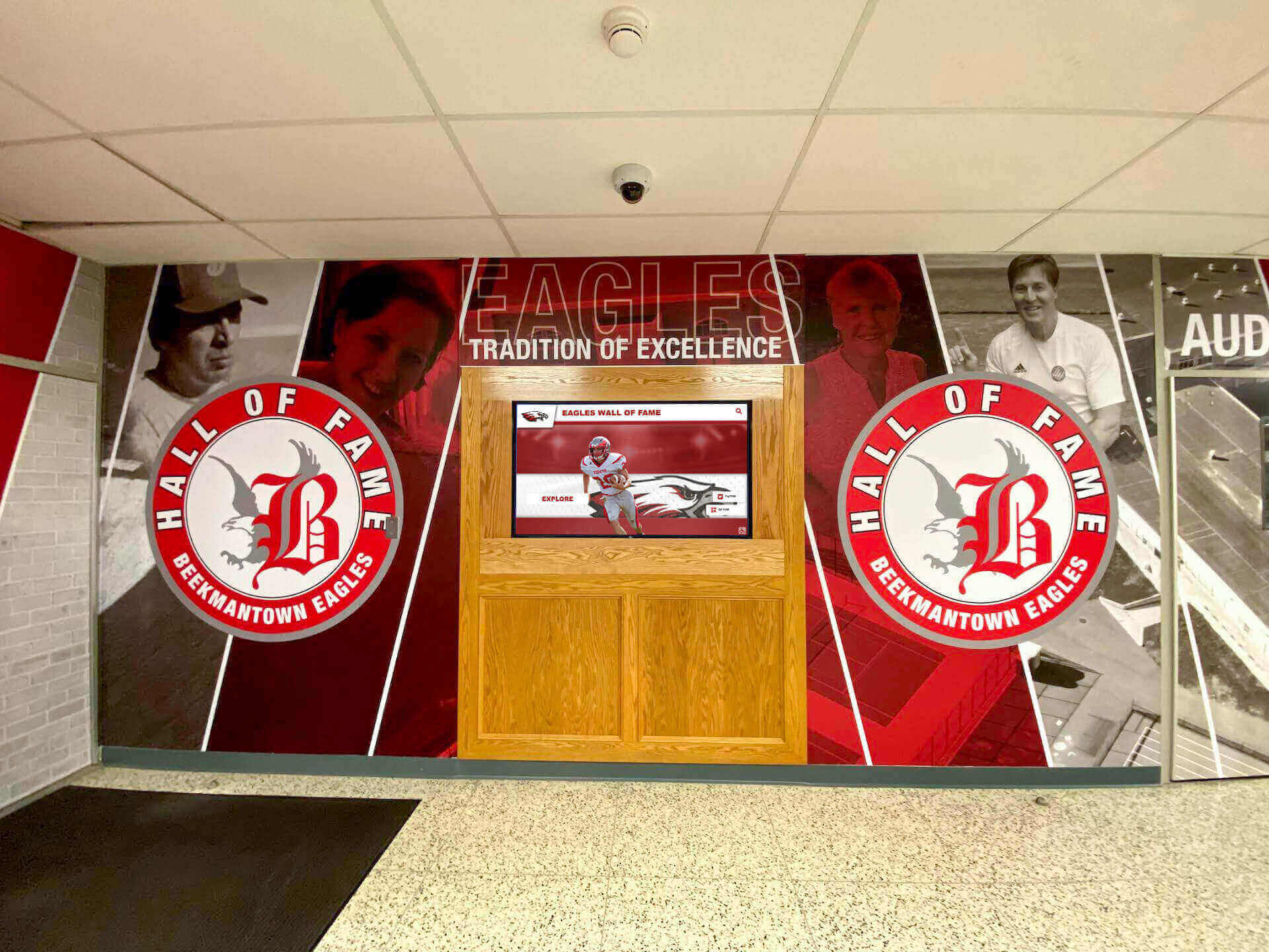 School lobby with large Eagles Hall of Fame mural and recognition displays