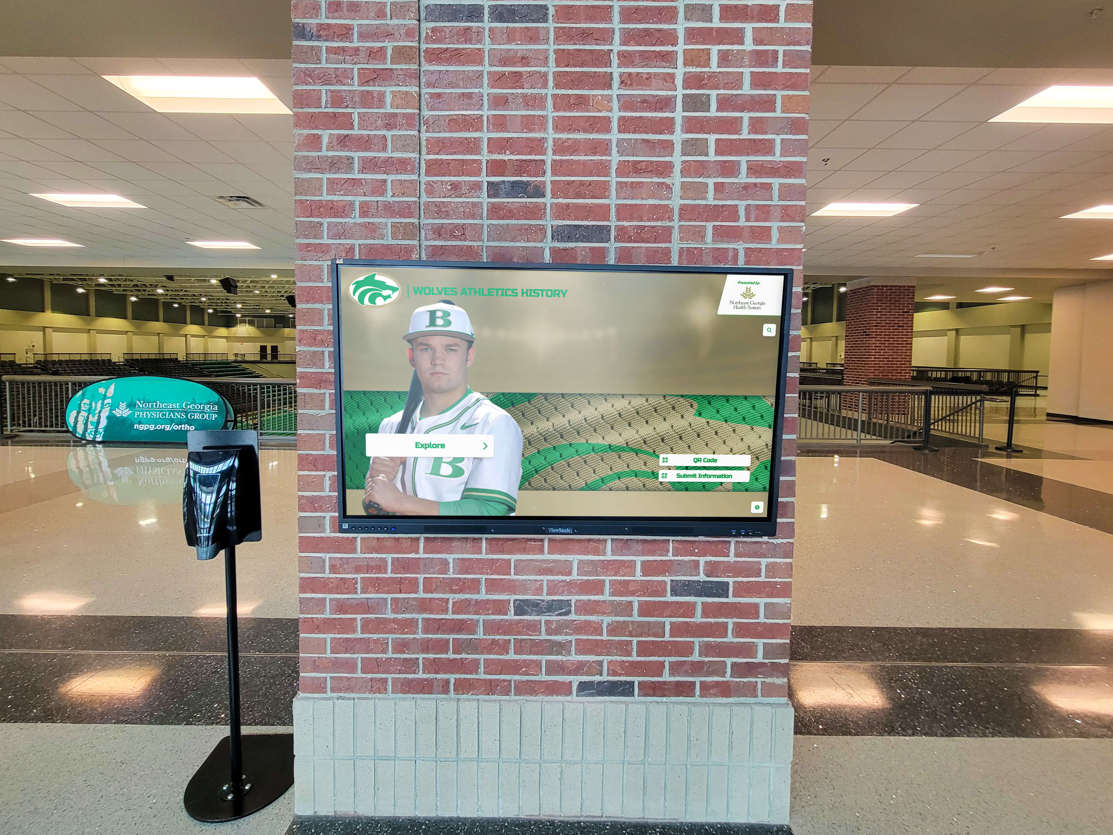 Digital display showcasing athlete in arena lobby