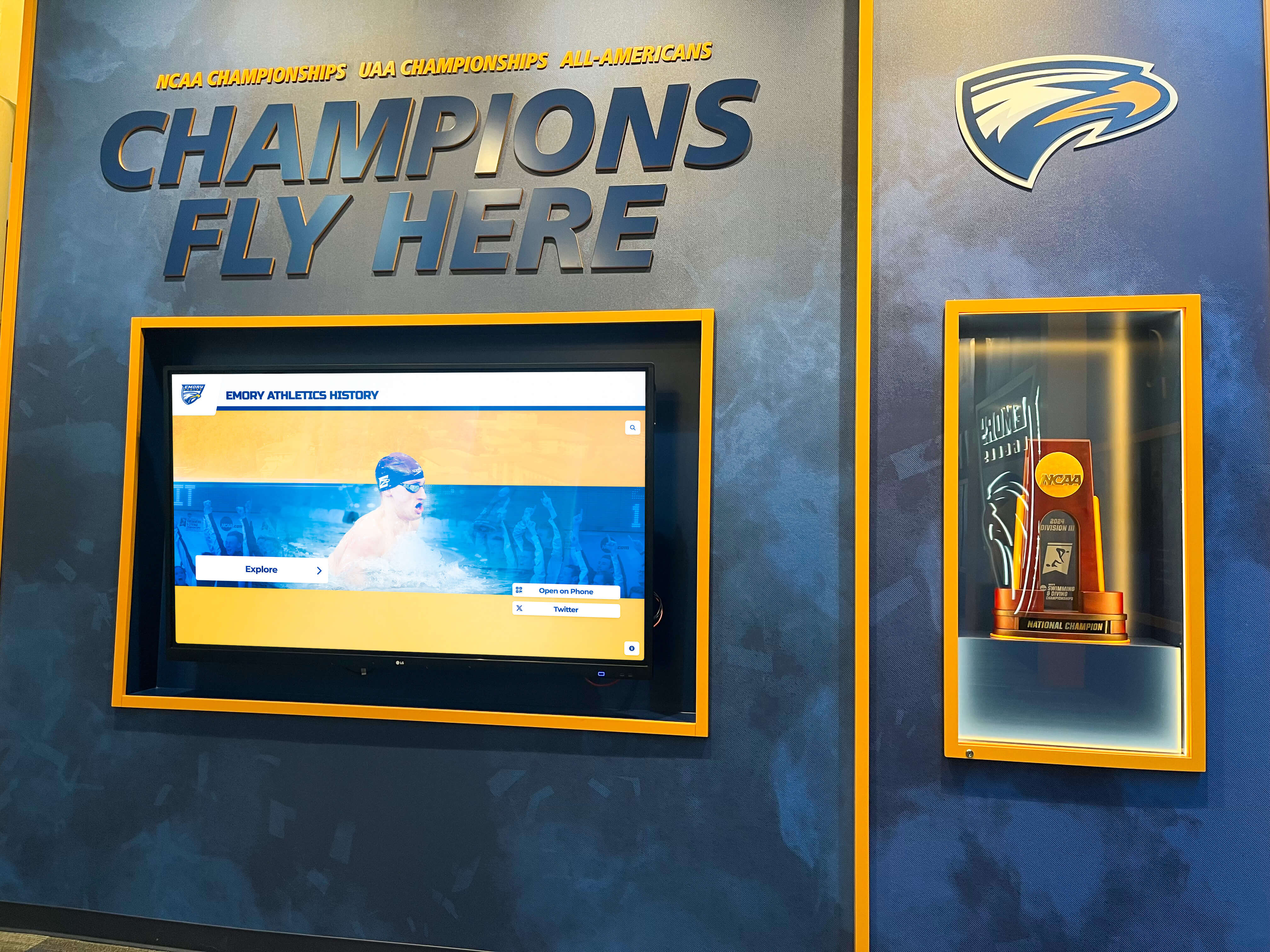 Emory athletics champions wall with swimming trophies and NCAA recognition