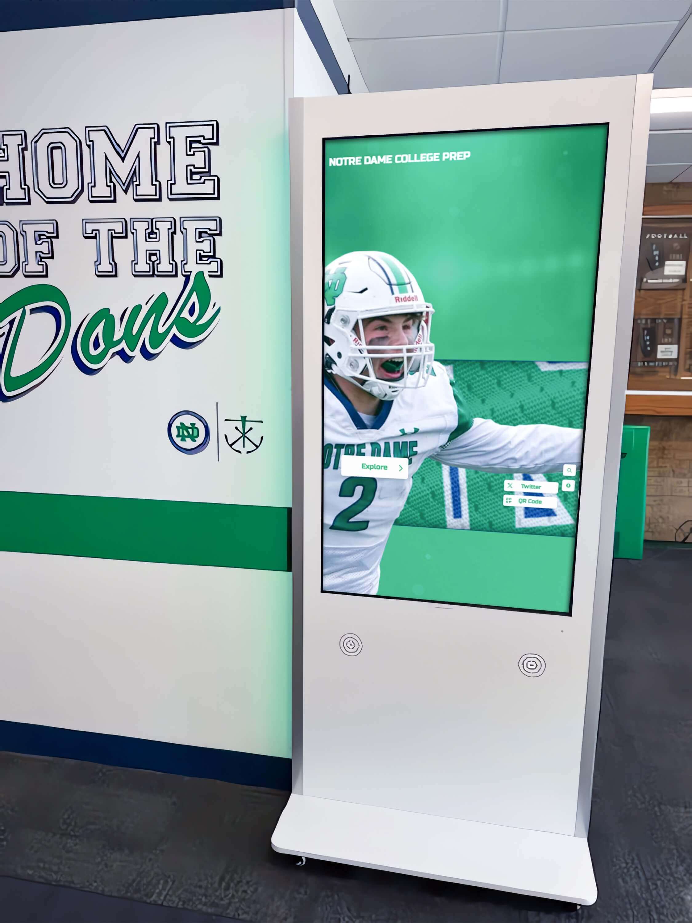 Interactive kiosk in school hallway displaying football achievements