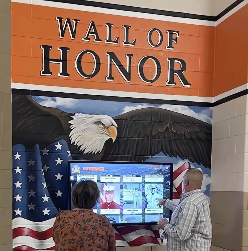 Military memorial wall with flag and interactive display